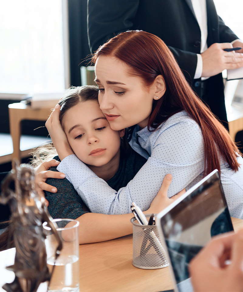 Mother hugging her daughter in a lawyer's office